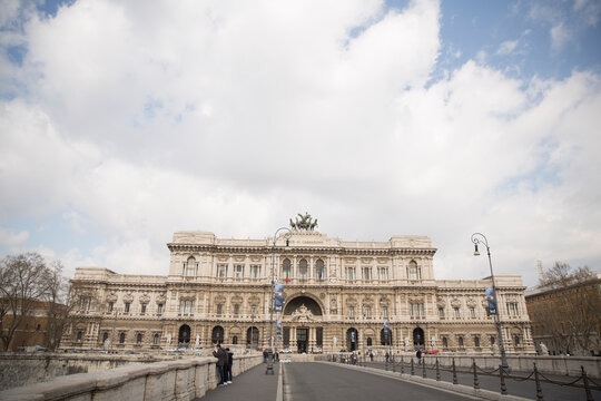 Rome, Italy - March 15, 2016: The majestic Supreme Court of Cassation, known as the Palazzaccio, stands prominently in the Prati district overlooking the Tiber River under a cloudy sky.