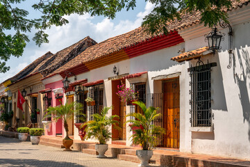 Obraz premium Colombia, city of Santa Cruz de Mompos, a street with colorful flowered houses in colonian style.