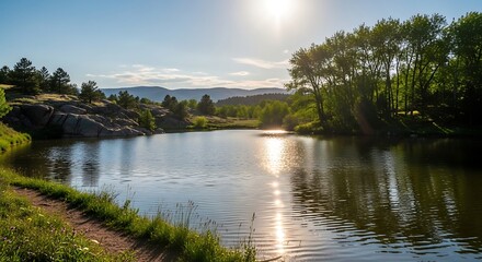 Fototapeta premium Serene Sunlit Lake Reflecting Trees and Mountains in Natural Landscape