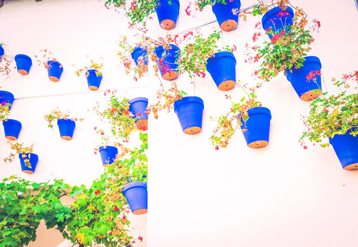 Poble Espanyol cortyard details, with traditional for Andalusia white walls and blue pots architecture, Barcelona, Catalonia Spain