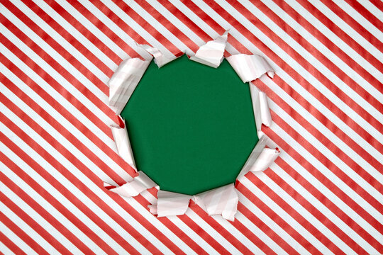 Gift wrapping paper tears from the center on a green background. Layout for discounts, text, etc