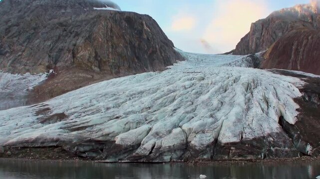 Experience the immense beauty of an Arctic glacier at dawn.