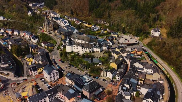 A panoramic Aerial view of the city and castle Clervaux in Luxembourg, on a sunny spring noon
