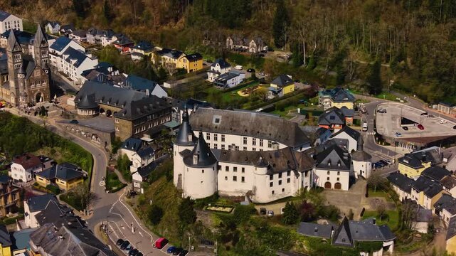 A panoramic Aerial view of the city and castle Clervaux in Luxembourg, on a sunny spring noon