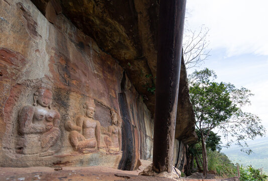 Ancient Khmer low relief sandstone carving of Hindu deities at Pha Mo E Daeng, Khao Phra Wiharn National Park, Thailand