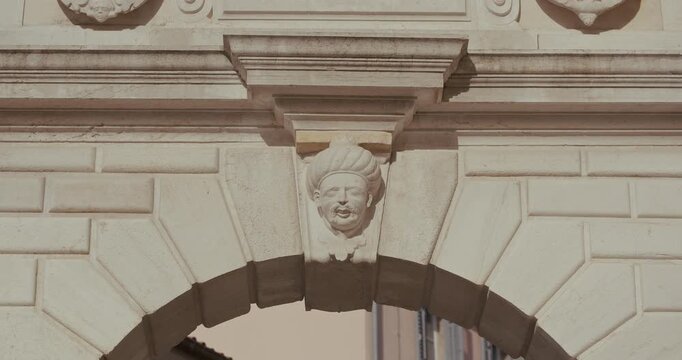 Stone head relief on Balbi's Arch on Marshal Tito Square in Rovinj, Istria, Croatia during the morning.
