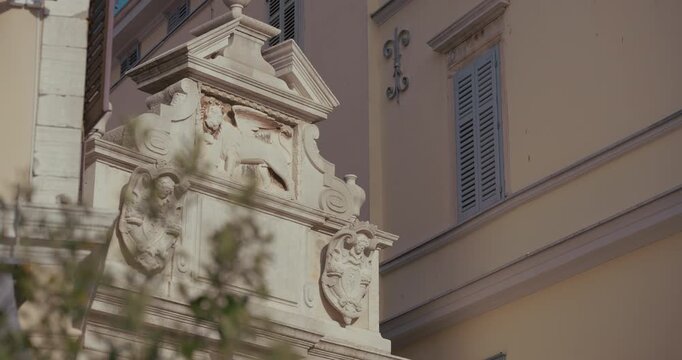 Decorative stone relief on Balbi's Arch on Marshal Tito Square in Rovinj, Istria, Croatia during the morning.