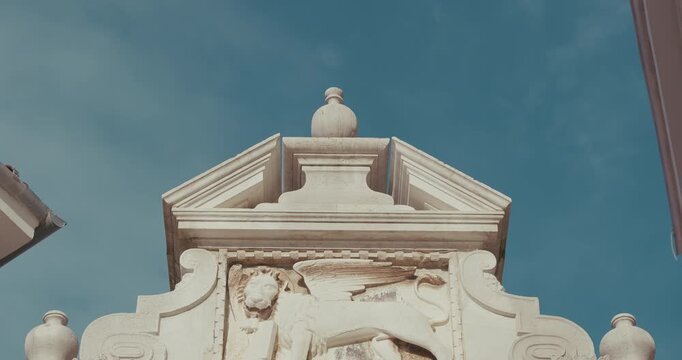 Winged lion relief on Balbi's Arch on Marshal Tito Square in Rovinj, Istria, Croatia during the morning.