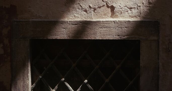 Metal window grille and weathered wall facade in the old town of Rovinj, Croatia during the afternoon.