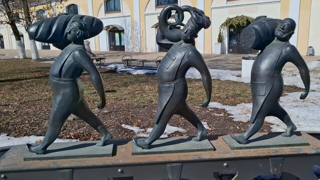 Bronze figures of market sellers with traditional bread and wooden barrel. Part of Khlebnaya Ploshchad installation. Public art reflecting historical trade traditions. Russia, Ryazan, March 25, 2026