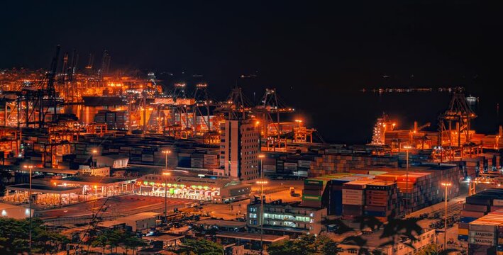 Illuminated Container Port with Cargo Cranes at Night