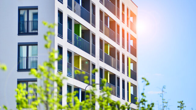 European residential architecture harmonizing with nature. Eco-friendly living in city with greens. Eco apartment building saving energy and fresh air concept. 