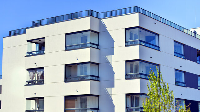 European residential architecture harmonizing with nature. Eco-friendly living in city with greens. Eco apartment building saving energy and fresh air concept. 