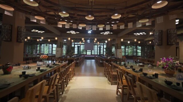 Traditional banquet hall with long wooden dining tables and chairs