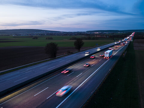 Aerial view of highway traffic traveling trough the countryside at night