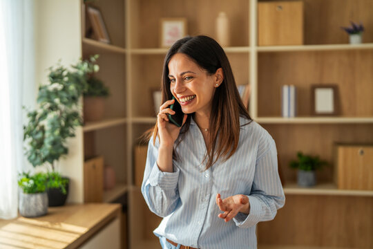 Happy woman talking on smart phone, laughing during call