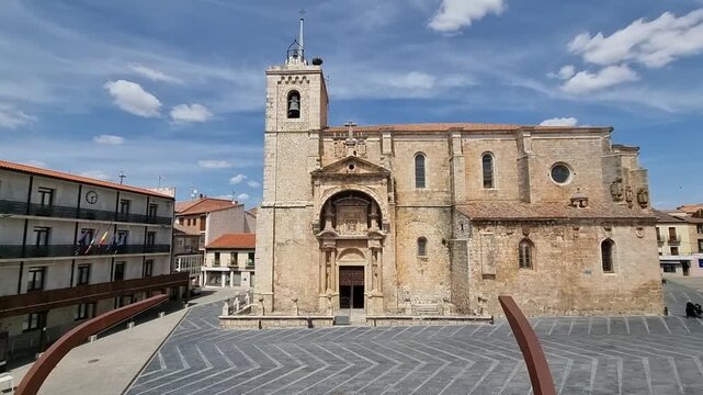 The ornate Renaissance portal of the Church of Nuestra Se&ntilde;ora de la Asunci&oacute;n in Roa de Duero, Burgos, Spain. A historic architectural landmark featuring detailed stone carvings and a bell tower.