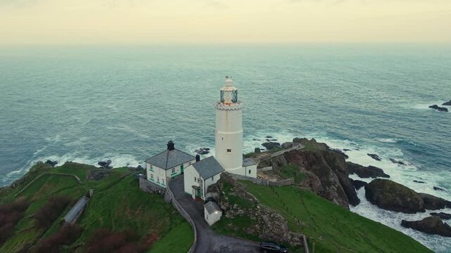 Aerial view of Start Point lighthouse in sunset, which was built in 1836 to protect shipping off Start Point, Devon, England. Drone POV of United Kingdom Landscapes from Devon county. 