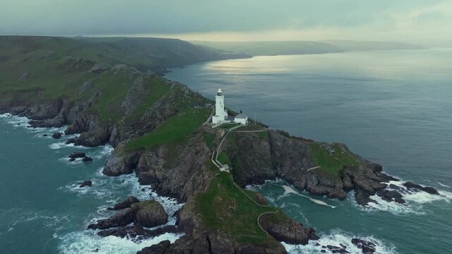 Aerial view of Start Point lighthouse in sunset, which was built in 1836 to protect shipping off Start Point, Devon, England. Drone POV of United Kingdom Landscapes from Devon county. 