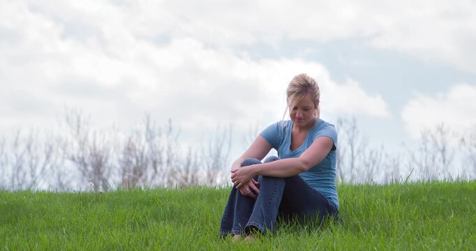 Cute girl sitting in grass 4k
