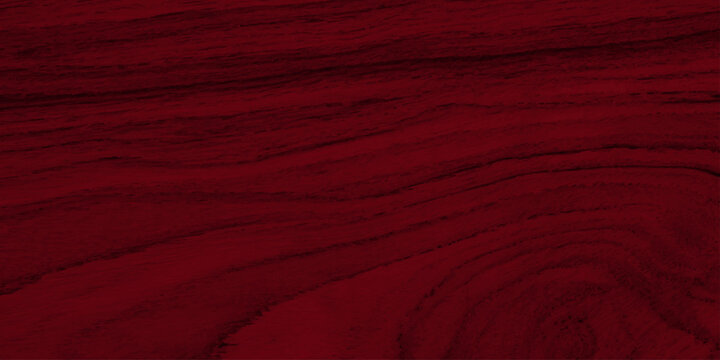 Deep red mahogany wood texture background with natural wavy grain patterns. A high-quality, close-up shot of dark red mahogany wood featuring rich, elegant wavy grain patterns