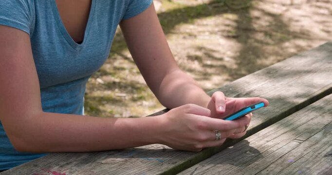Hands of female texting outdoors 4k

