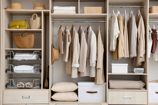 Large wardrobe with different stylish clothes and home stuff