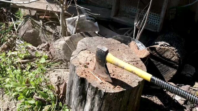to split a log in two, causing dust to fly to the side, in the countryside. High quality 4k footage