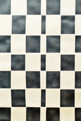 Fototapeta premium A simple yet stylish design featuring a black and white checkered pattern vertical frame