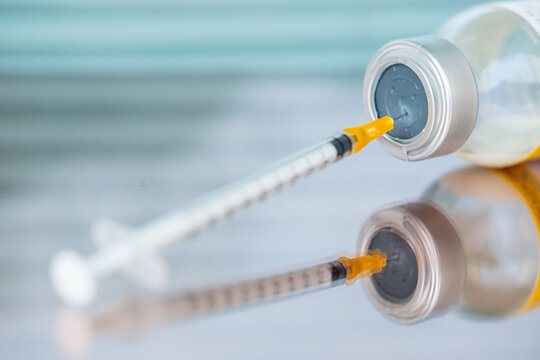 syringe and empty vial on clinical surface, end life decision, ethical dilemma euthanasia, assisted dying, vaccination sterile equipment, clinical sterile environment, control over life and death