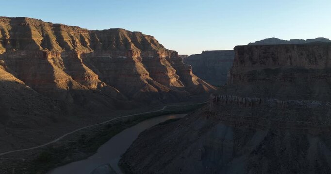 Sunset aerial panning around Roan Cliffs along Green River in Gray Canyon in Utah
