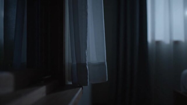 Curtains drawn in a dimly lit room.