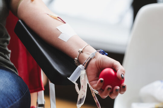 Blood donor hand detail during blood donation procedure