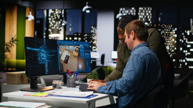 Diverse team of engineers using artificial intelligence to design a floor plan, working together with neural networks and computer aided apartment layout on architectural software. Camera B.