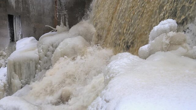 Joa Waterfall in Winter Frozen Banks, Icicles, and a Flowing Cascade Contrasting Snow