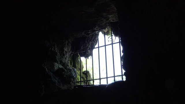 Barred up hole in cave creating prison 4k

