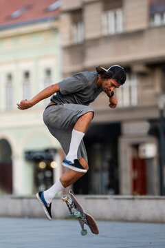 Young man performing skateboard flip trick outdoors