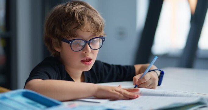 Focused Student Working. Thoughtful Boy Methodically Working Through Workbook Questions Attentively