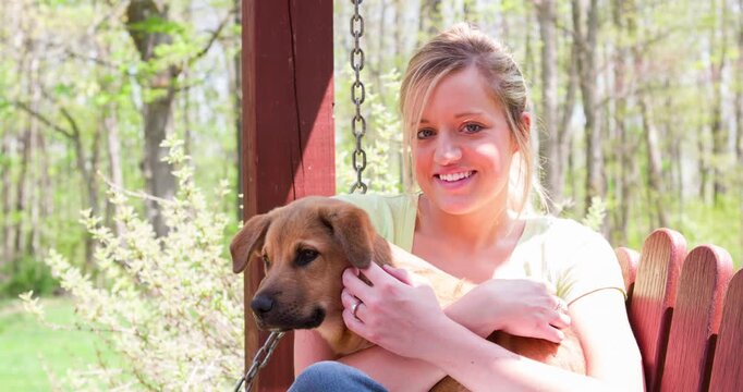 Young female sitting with dog on bench 4k
