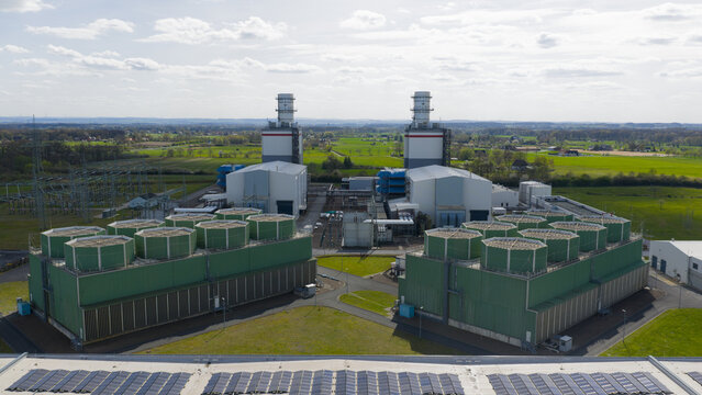 Aerial view of the Trianel Gaskraftwerk Hamm power plant featuring industrial cooling towers and chimneys under a bright sky Hamm, Nordrhein-Westfalen, Germany.