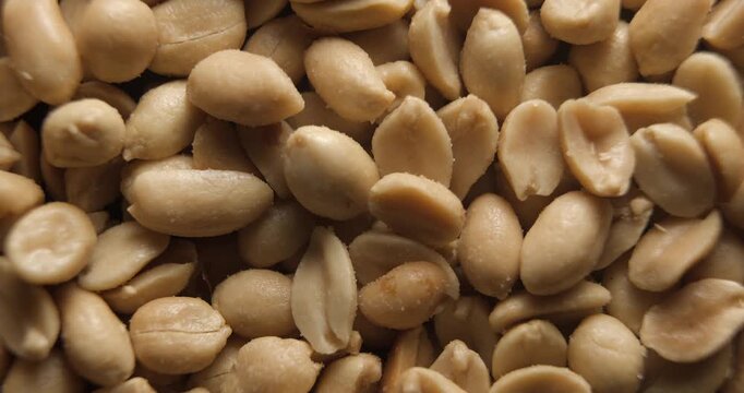Grilled and salted peanuts close up studio shot over rotating