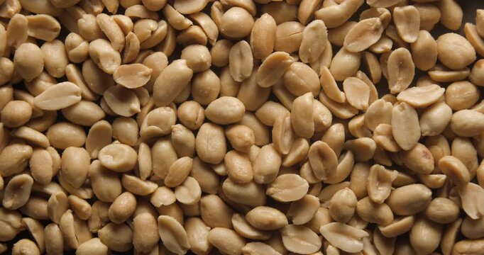 Grilled and salted peanuts close up studio shot over rotating