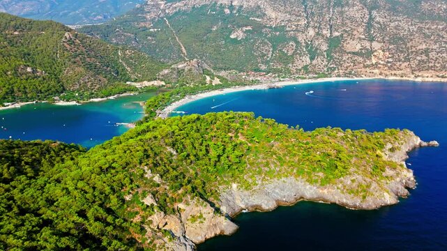 Drone view of Oludeniz Blue Lagoon, Turkey. Green peninsula, turquoise water and mountains create a famous Mediterranean travel scene.