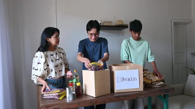 Young people preparing donation boxes with food and clothing