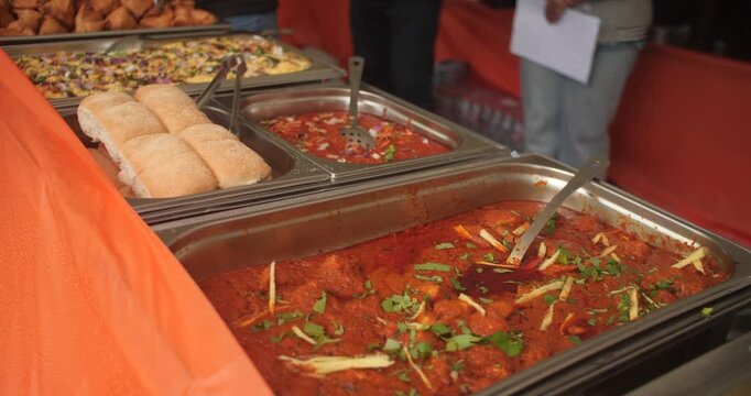 Indian street food hot curry rice samosa fried in serving buffet trays