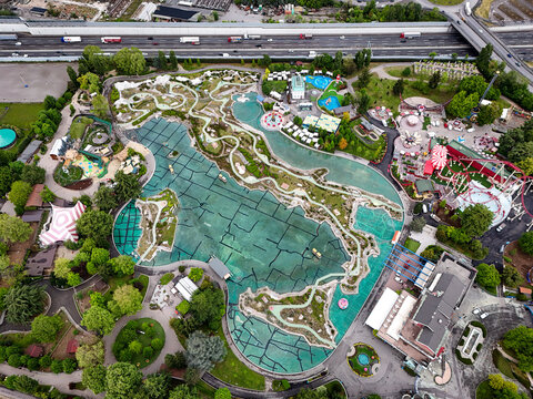 Aerial view theme park featuring the Minitalia miniature map of Italy surrounded by water and lush greenery.