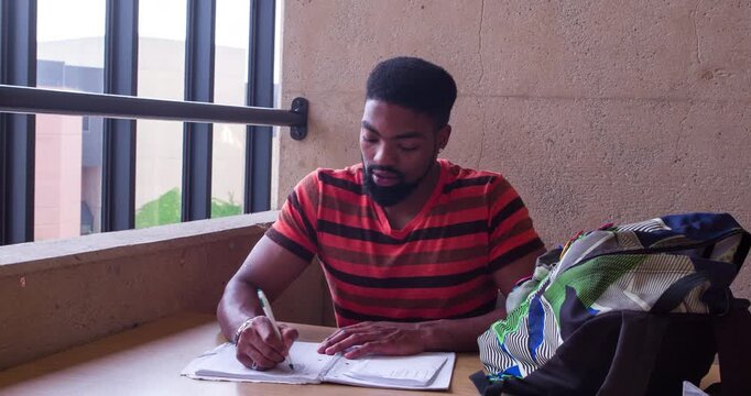 Student working on note pad of paper 4k
