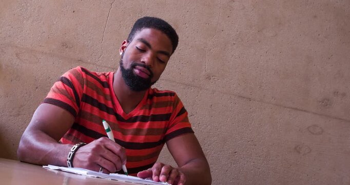 Young college student writing on note pad 4k
