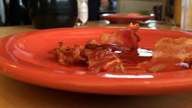 Pouring syrup on bacon
