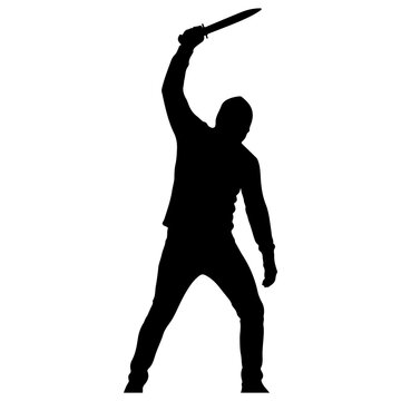 Silhouette of a person holding a knife raised high.